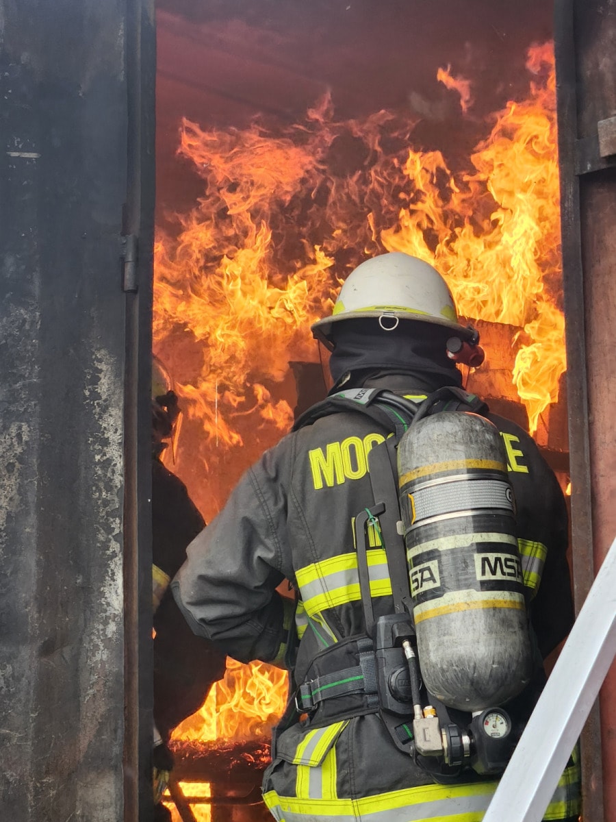 Moose Lake firefighter in full gear at a structure fire