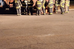 Group in uniforms on paved surface — chimney fire training February 2024
